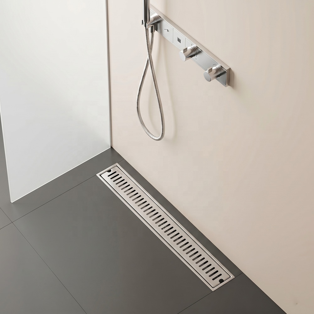 Dark stone bathroom floor with a AERLO linear shower drain